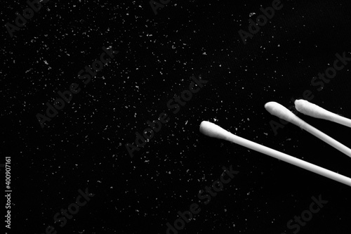 Cotton buds and dandruff on black cloth