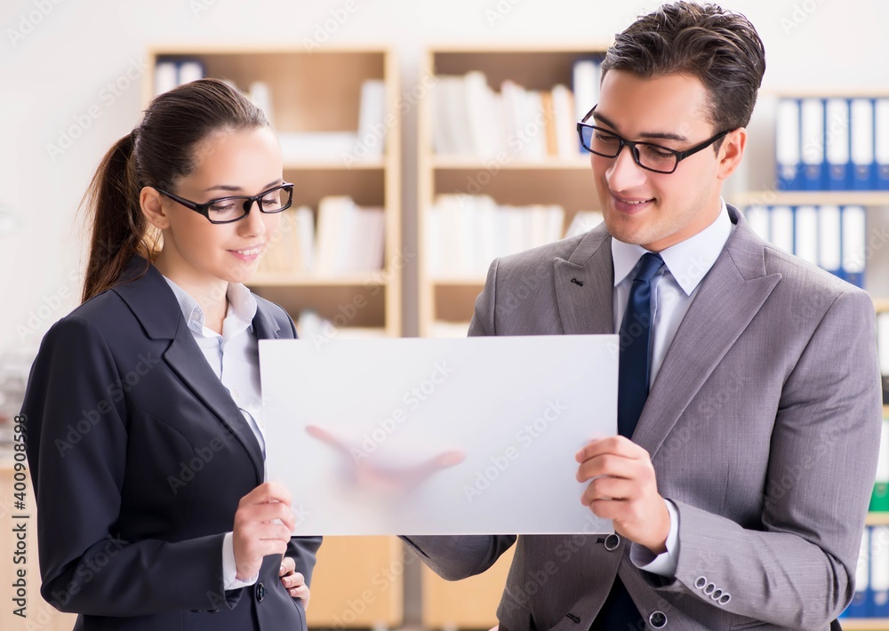 Businessman and businesswoman having discussion in office Businessman and businesswoman having discussion in office