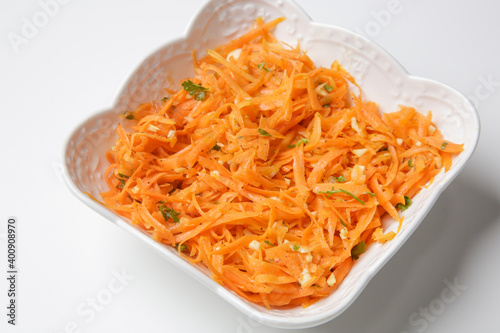 Simple carrot salad in a bowl, fresh and healthy vegetarian meal with parsley and garlic dressing
