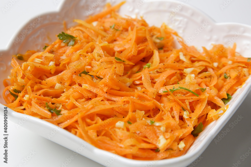 Simple carrot salad in a bowl, fresh and healthy vegetarian meal with parsley and garlic dressing Simple carrot salad in a bowl, fresh and healthy vegetarian meal with parsley and garlic dressing
