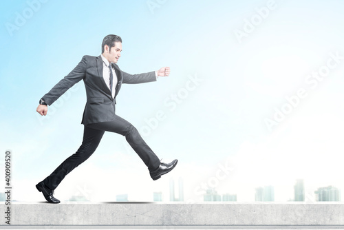 Asian businessman walking on the rooftop