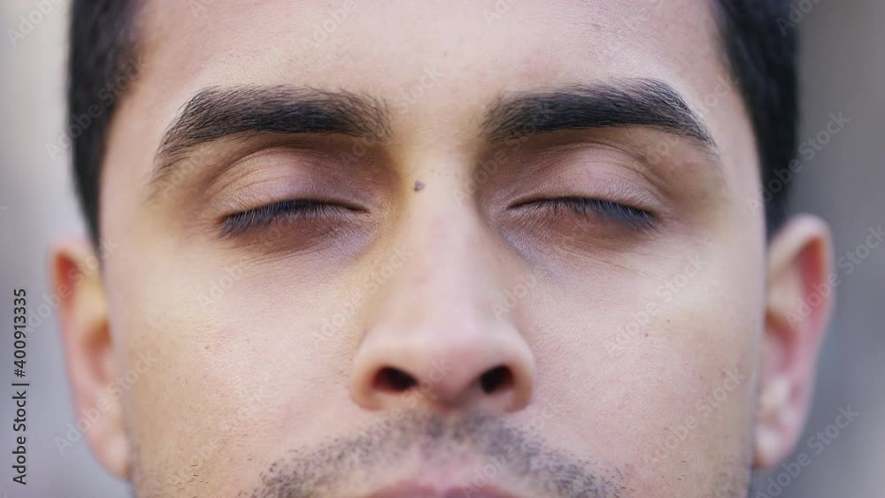 Eyes of an Indian male opening and looking straight to camera 