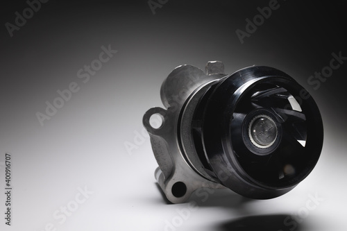 Car engine coolant water pump new on a gray background. Spare parts