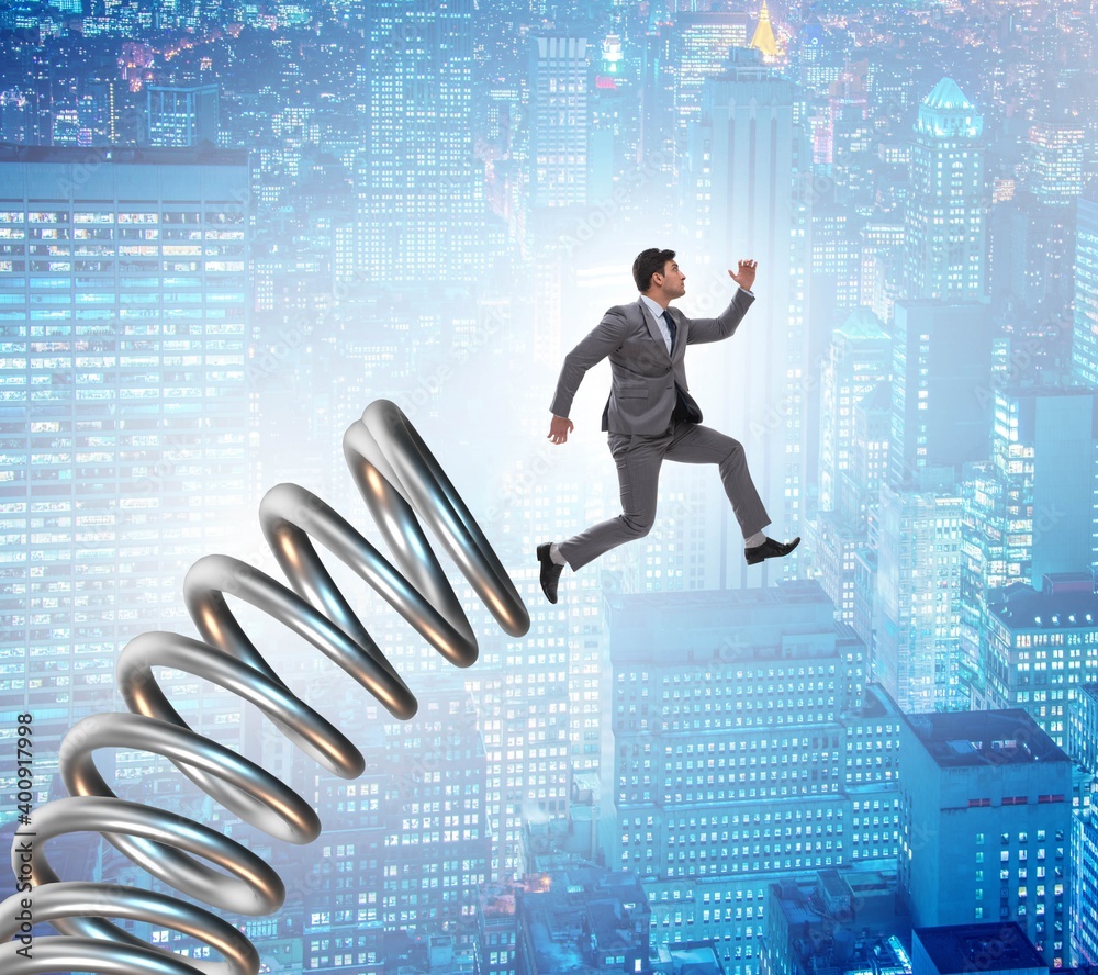 Businessman jumping from spring in promotion concept Businessman jumping from spring in promotion concept