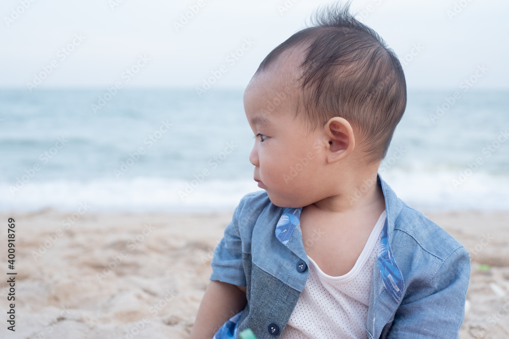 Adorable Cute Asian baby boy playing with beach toys on tropical beach Adorable Cute Asian baby boy playing with beach toys on tropical beach