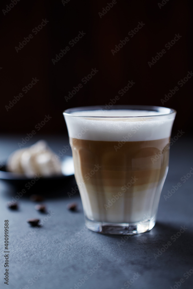 Coffee with milk on dark stone background. Close up. Coffee with milk on dark stone background. Close up.