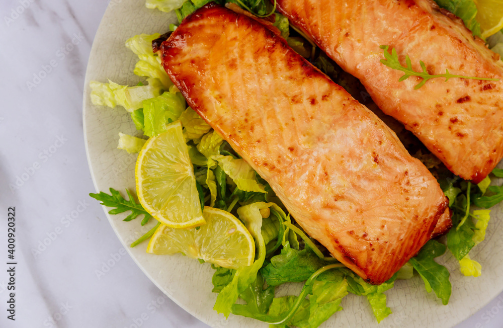 Grilled salmon with salad served on gray plate. Grilled salmon with salad served on gray plate.