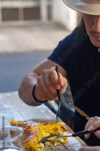 Men eating a cachapa