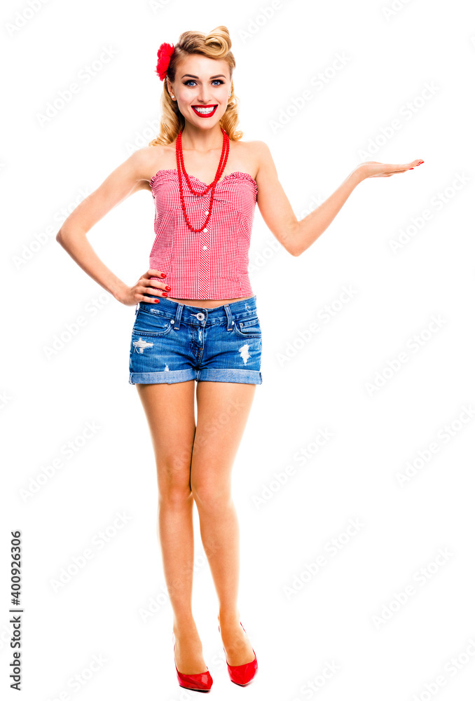 Amazed happy woman holding or giving something. Excited girl in pin up, showing product or copy space. Retro and vintage. Isolated over white background. Full body. Amazed happy woman holding or giving something. Excited girl in pin up, showing product or copy space. Retro and vintage. Isolated over white background. Full body.