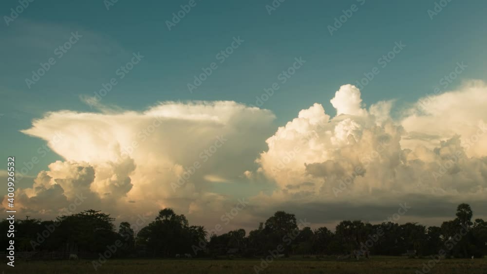 Cumulus bubbling up on the horizon during sunset, rainy season, Asia. Shot with vintage Canon lens, pan. Cumulus bubbling up on the horizon during sunset, rainy season, Asia. Shot with vintage Canon lens, pan.