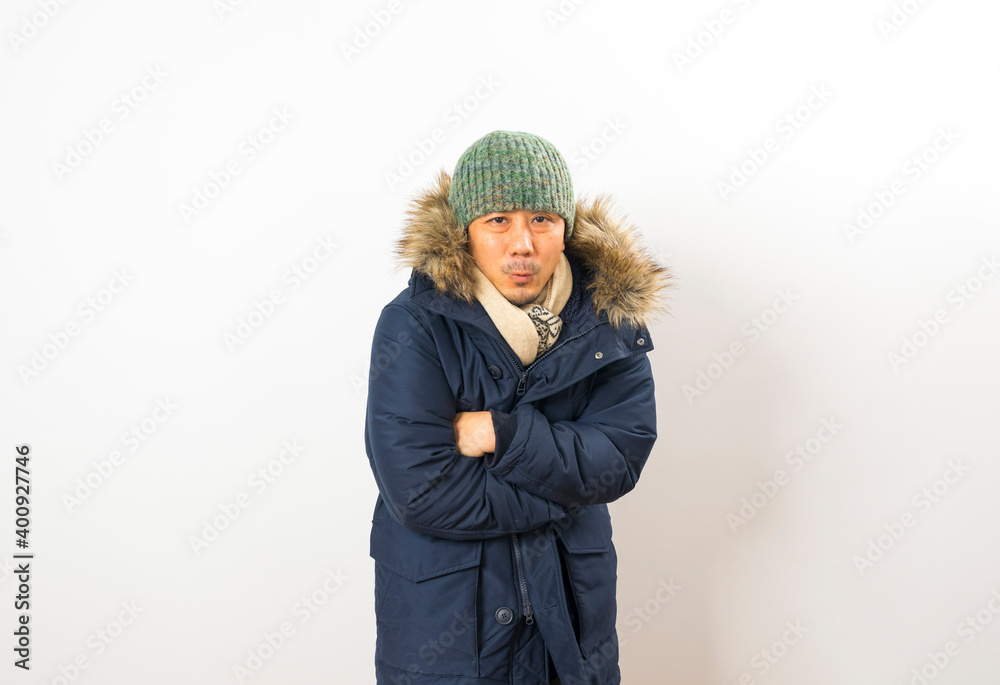 Handsome asian man dressed with winter clothing, hat and scarf isolated on white background