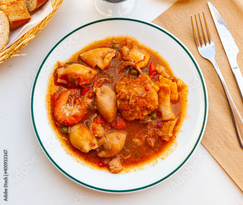 фотографія Traditional Spanish seafood zarzuela - stewed fish fillets, sea molluscs and cru