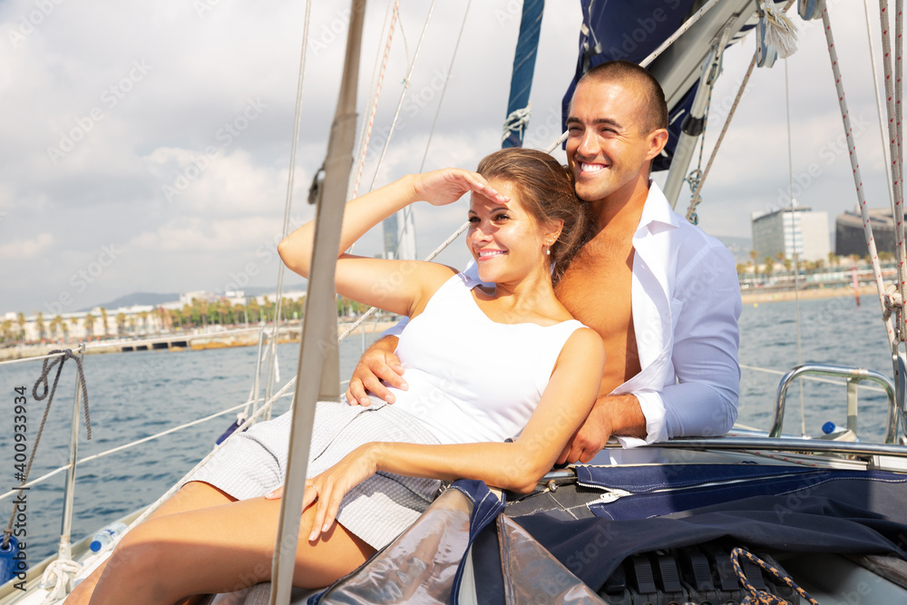 Portrait loving couple sailing on yacht in calm blue sea along Spanish coast during romantic trip