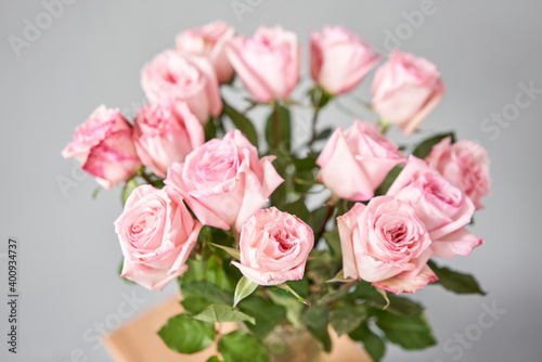 pink rose in a vase . Summer background. Bouquet of roses present for Mothers Day. Photo of Flowers for a catalog of flower online store and delivery.