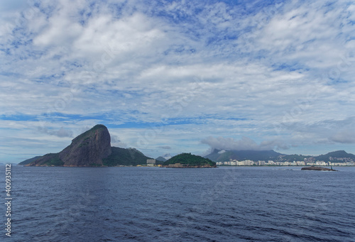 Copacabana beach visible from a Vessel heading in to the Port of Rio, overlooked by the dramatic mountain of Pedra da Gavea.