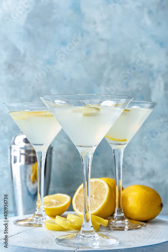 Glasses of fresh martini on color background