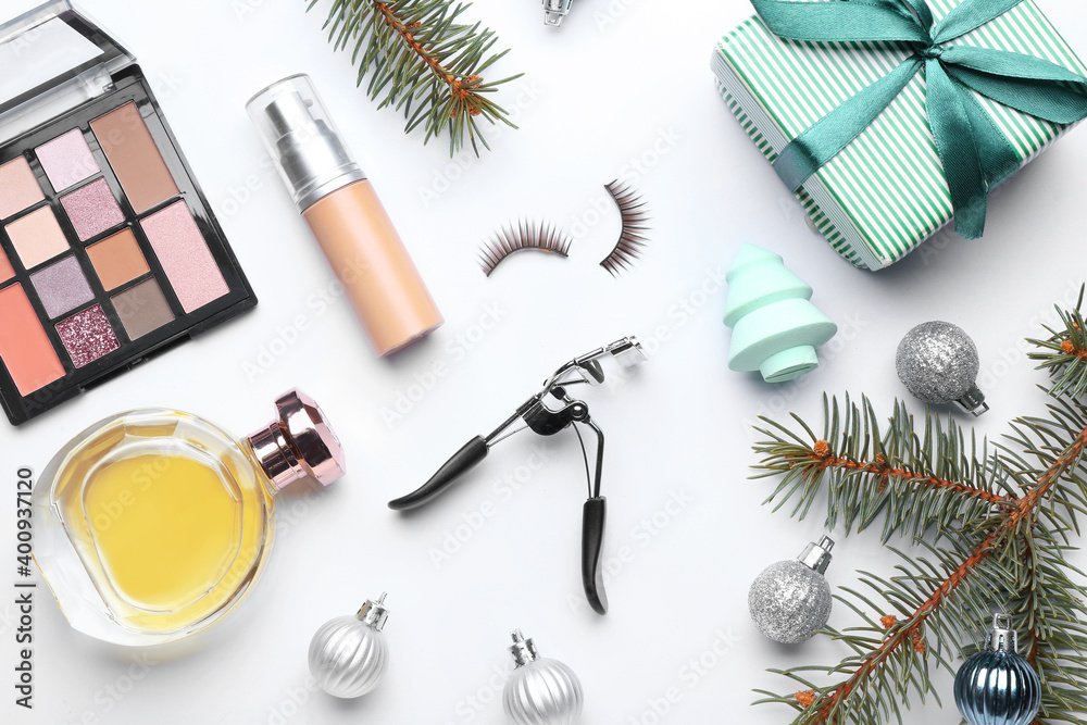 Christmas composition with cosmetics on white background Christmas composition with cosmetics on white background