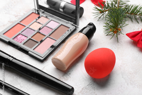 Christmas composition with cosmetics on light background