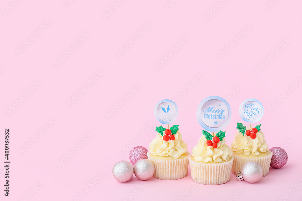 Tasty Christmas cupcakes on color background
