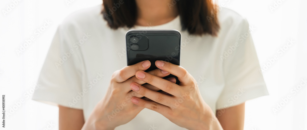 Close-up of woman holding a smartphone and using online social on lifestyle. Technology for communication concept. Close-up of woman holding a smartphone and using online social on lifestyle. Technology for communication concept.