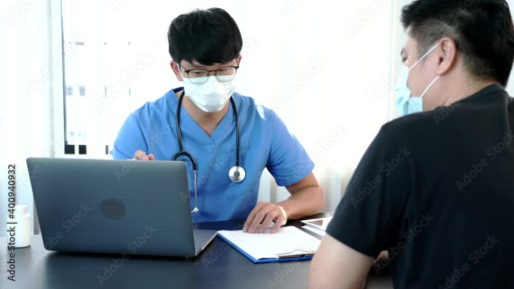 Asian man doctor wear protection face mask during coronavirus and flu outbreak is taking care examining sick patient in hospital. Asian man doctor wear protection face mask during coronavirus and flu outbreak is taking care examining sick patient in hospital.