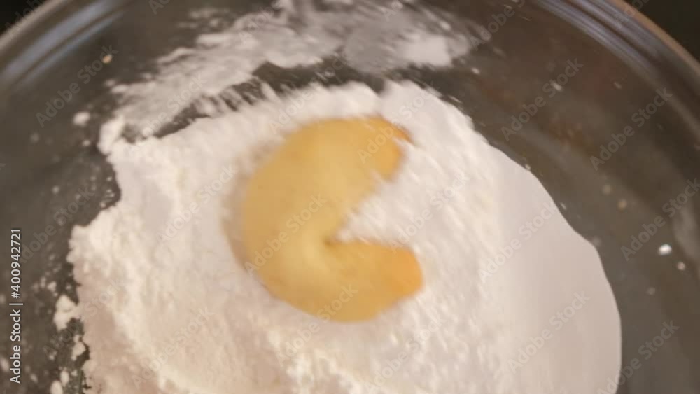 Making Vanilakipferl cookies, coating the cookie in icing sugar. Making Vanilakipferl cookies, coating the cookie in icing sugar.