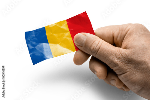 Hand holding a card with a national flag the Chad