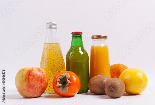 Citrus juice and fruits on wooden background. Selective focus.