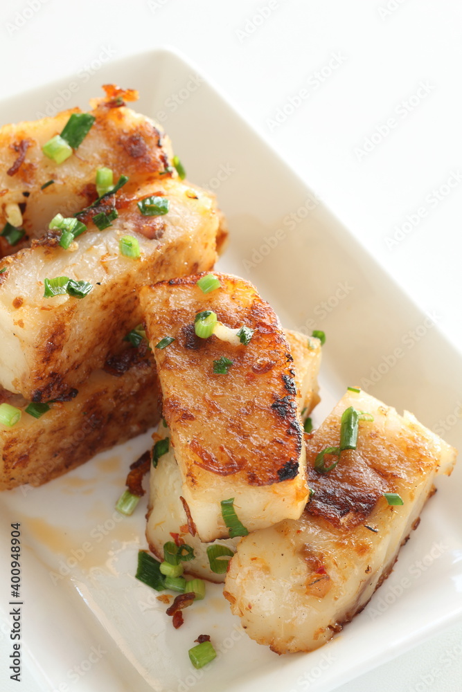 Chinese New Year food, turnip cake on dish also for dim sum yam cha cuisine Chinese New Year food, turnip cake on dish also for dim sum yam cha cuisine