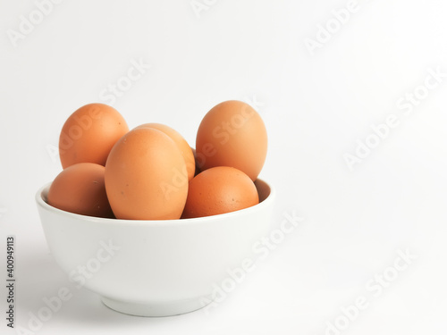 Chicken eggs in a bowl isolated on white background.