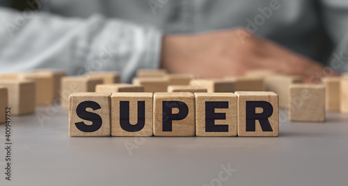 The word Super made from wooden cubes. Shallow depth of field on the cubes