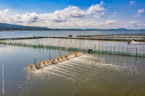 Aerial view of white shrimp ( prawn ) farm with aerator pump in front of O Loan lagoon, Phu Yen, Vietnam.