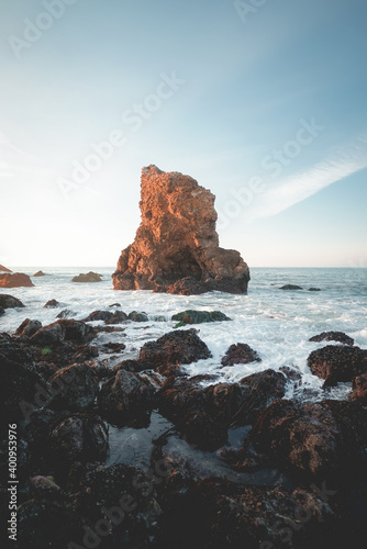 Rock formation in the sea shallows at sunset