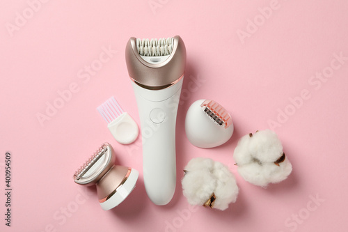 Epilator with nozzles on pink background, space for text photo