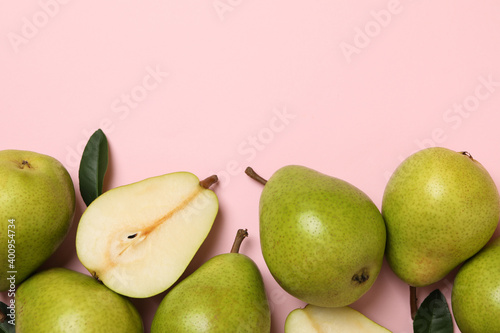 Fresh green pears on pink background, top view