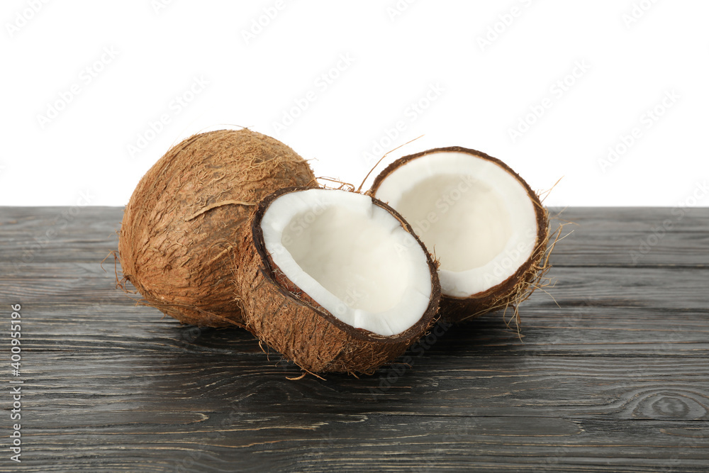 Fresh coconut on wooden table, isolated on white background Fresh coconut on wooden table, isolated on white background