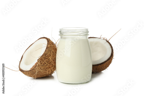 Coconut and jar of coconut milk isolated on white background