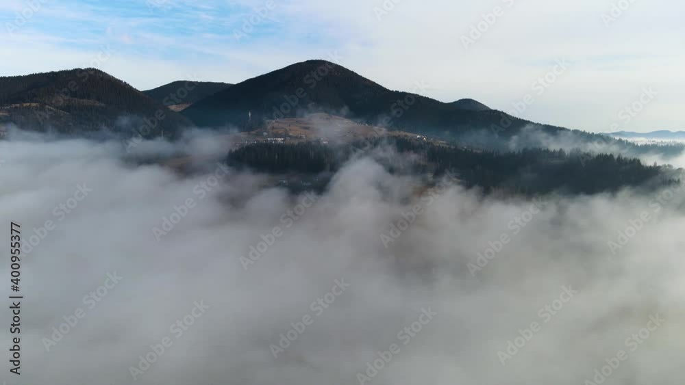 Flying through the clouds above mountain tops. High peaks wonderful morning sunrise natural Landscape Flying through the clouds above mountain tops. High peaks wonderful morning sunrise natural Landscape