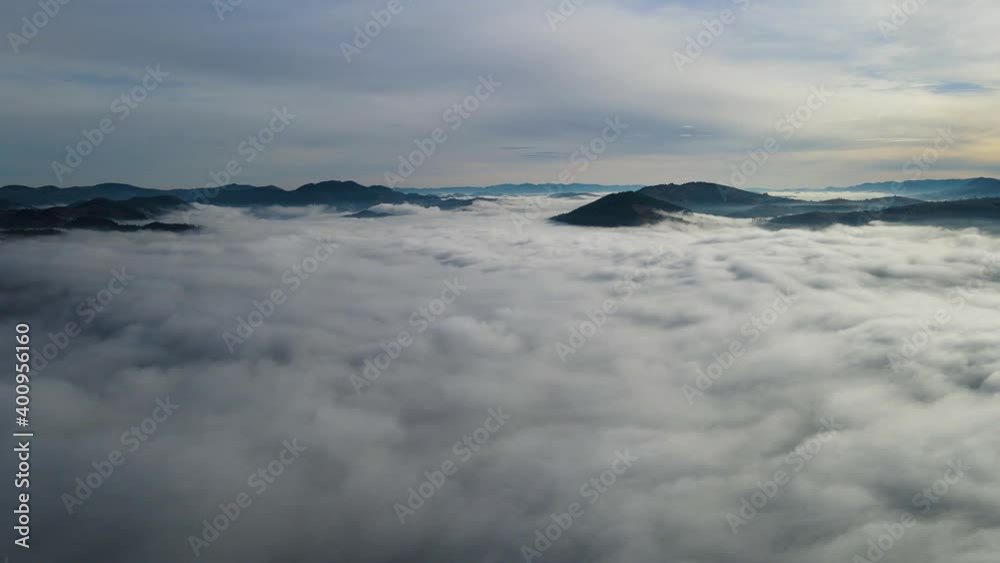 Flying through the clouds above mountain tops. High peaks wonderful morning sunrise natural Landscape Flying through the clouds above mountain tops. High peaks wonderful morning sunrise natural Landscape