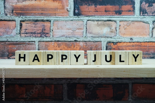 Happy July alphabet letter on shelves wooden background