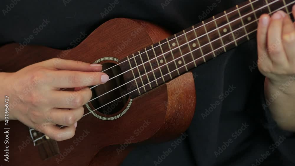 playing the ukulele close up playing the ukulele close up