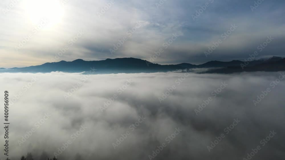 Flying through the clouds above mountain tops. High peaks wonderful morning sunrise natural Landscape Flying through the clouds above mountain tops. High peaks wonderful morning sunrise natural Landscape