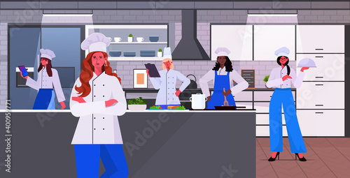 mix race female cooks in uniform women chefs cooking together food industry concept restaurant kitchen interior horizontal vector illustration