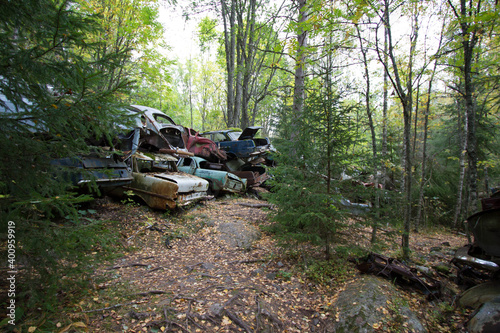 rusty old vintage cars, some with missing doors and windows, Bastnäs, Car Cemetry, damaged cars in Sweden close to norway photo