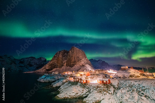 Aurora borealis on the Hamnoy village in Lofoten islands, Norway. Green northern lights above mountains. Night sky with polar lights. Night winter landscape. © Tracy Ben