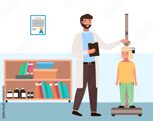 Doctor measures the child s height. Little patient on consultation in the therapist s office. Girl on medical check-up with male pediatrician doctor. Physical examination of the process of growing
