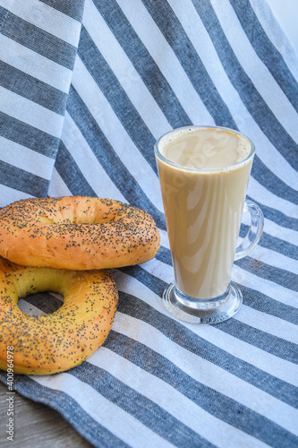 Fresh homemade Poppy bagels bread with cup of coffee, latte machiato or cocoa, cappuccino, breakfast time, Crispy crunchy bagel simits, hot brewed cup of coffee photo