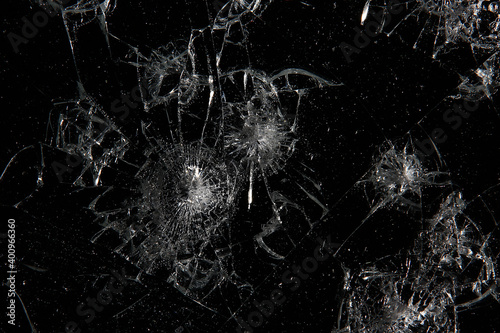 cracks on black glass background, broken abstract glass hole destruction concept photo