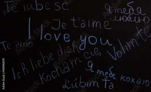 The word "I love you" is written in different languages ​​and colors on the board. St. Valentina. The concept of love. Background