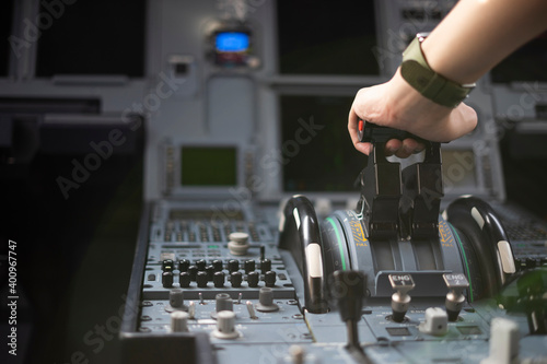 Canvas-taulu Cropped hands of pilot flying a commercial airplane, cockpit view close up of hands